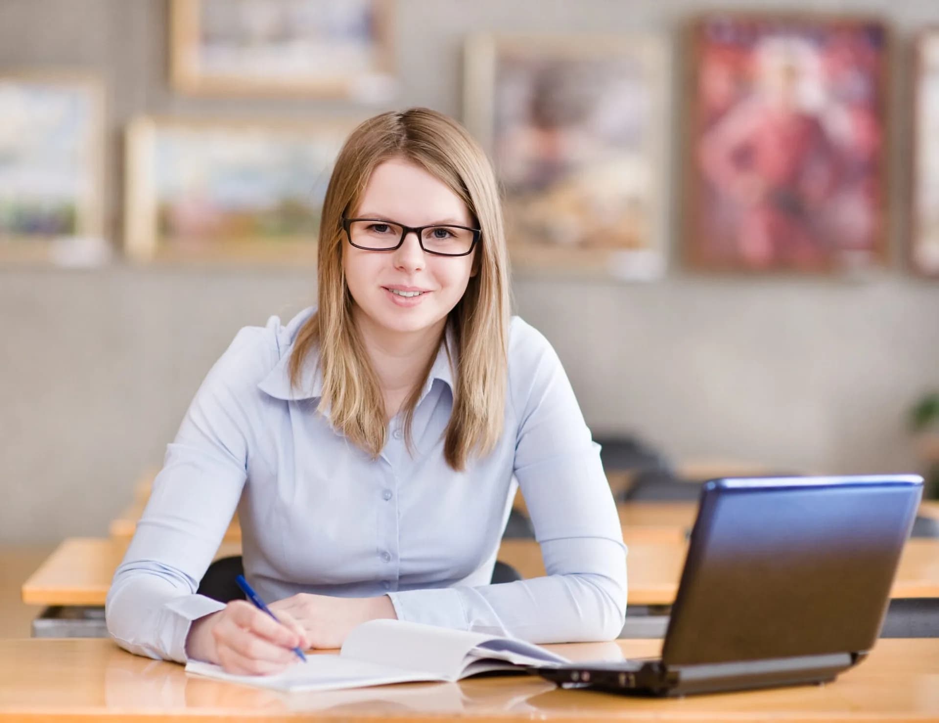 online middle school teacher at desk looking at camera - Virtual Prep Indiana